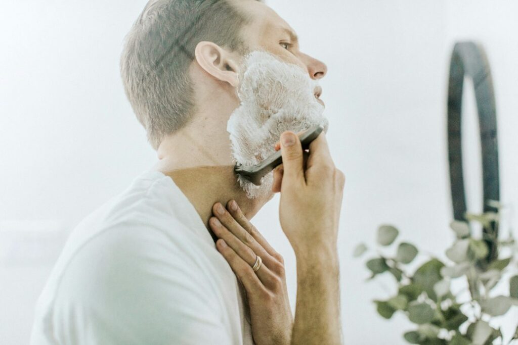Chrome safety razor on a white surface, ready for a slow wet shave